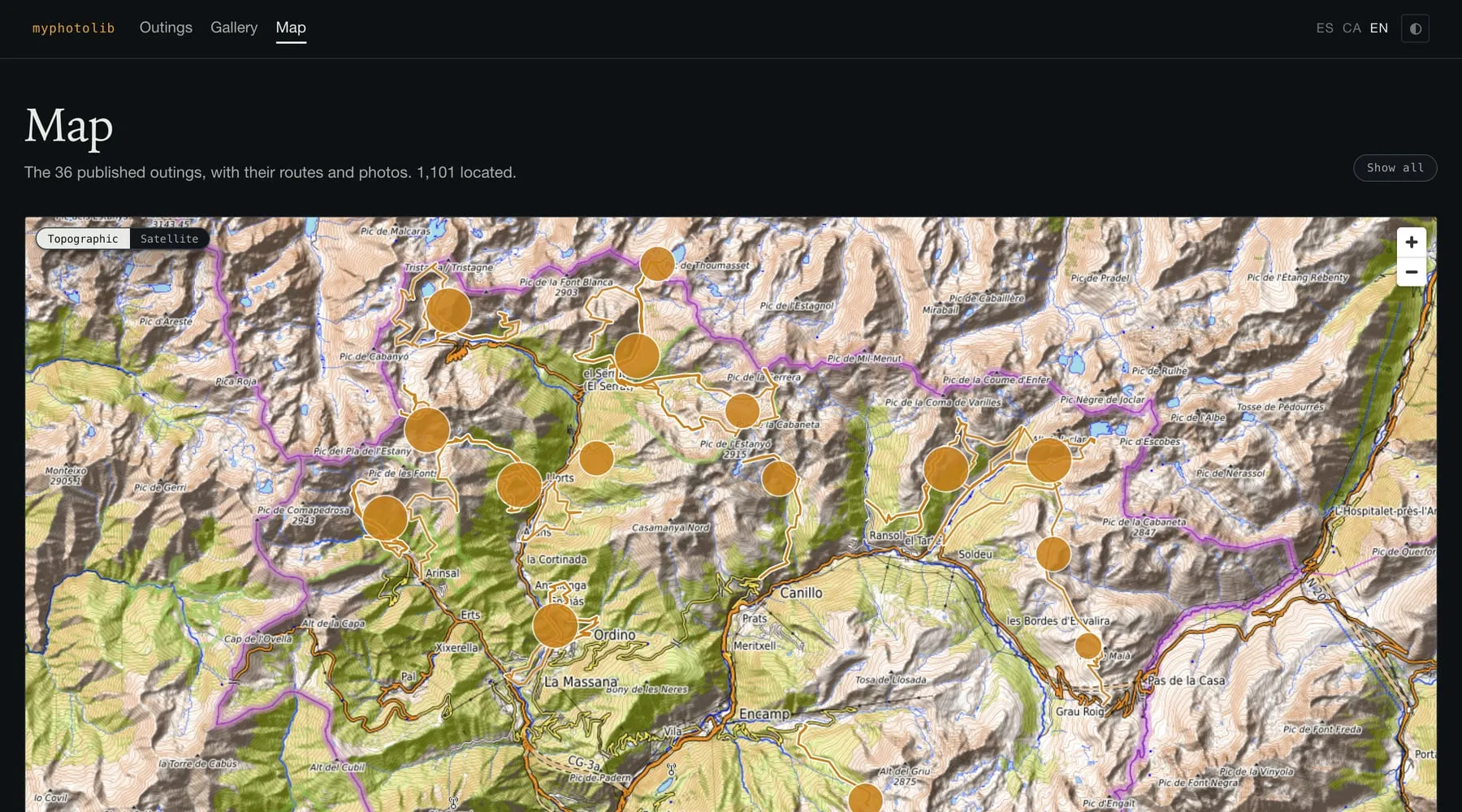 The global map: all 36 tracks drawn over Andorra in amber, with photo clusters as filled circles sized by count.